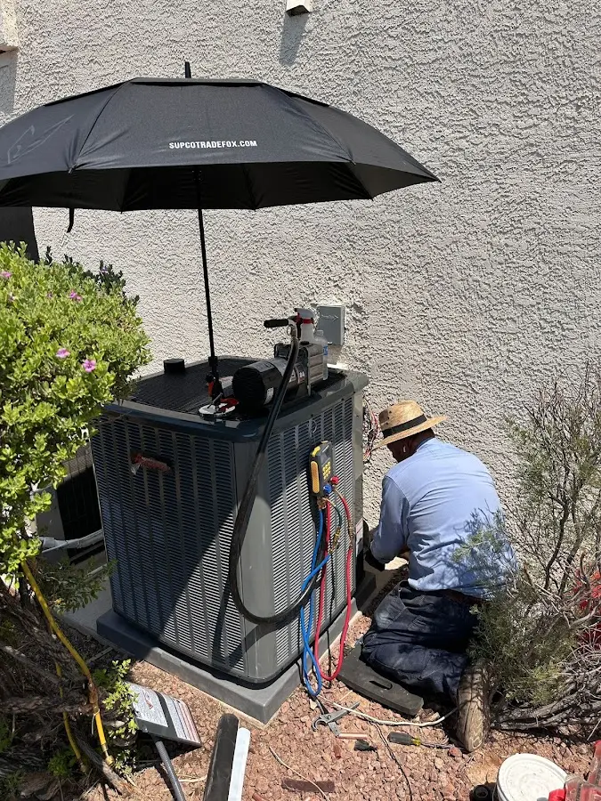 HVAC technician performing outdoor AC maintenance in Solana Beach